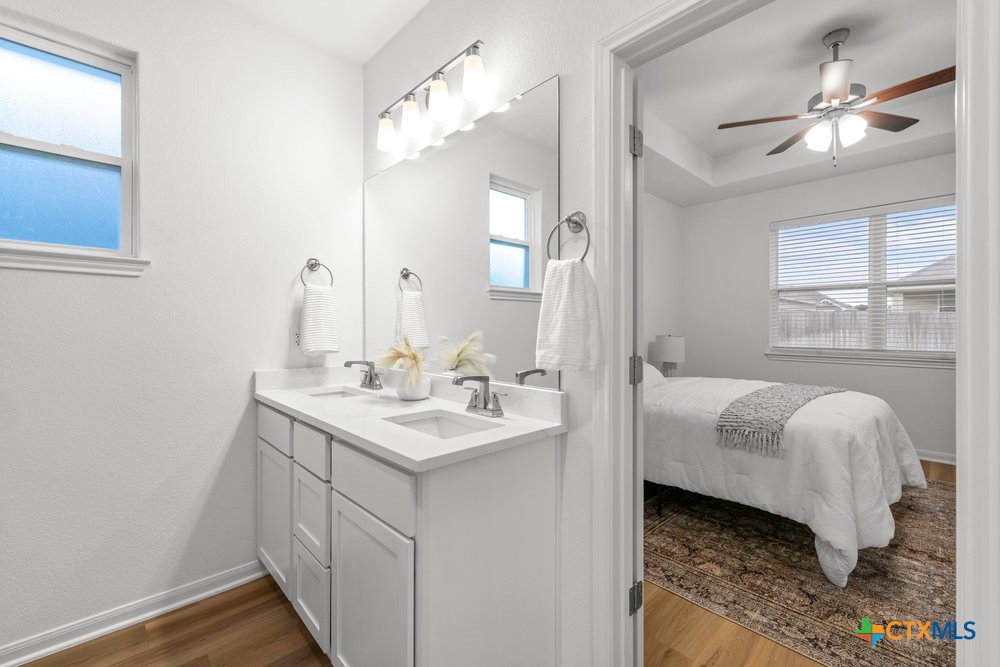 8114 Timber Hollow Lane Temple, TX 76502 - Photo 28 of 34 a en suite bathroom with a double vanity sink a mirror and a shower