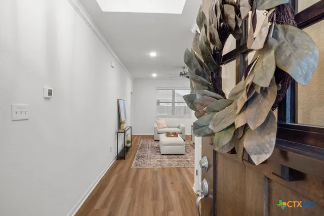 a view of entryway and hall with wooden floor