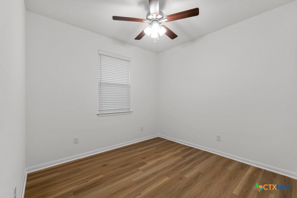 8114 Timber Hollow Lane Temple, TX 76502 - Photo 8 of 34 a view of a room with wooden floor and a ceiling fan