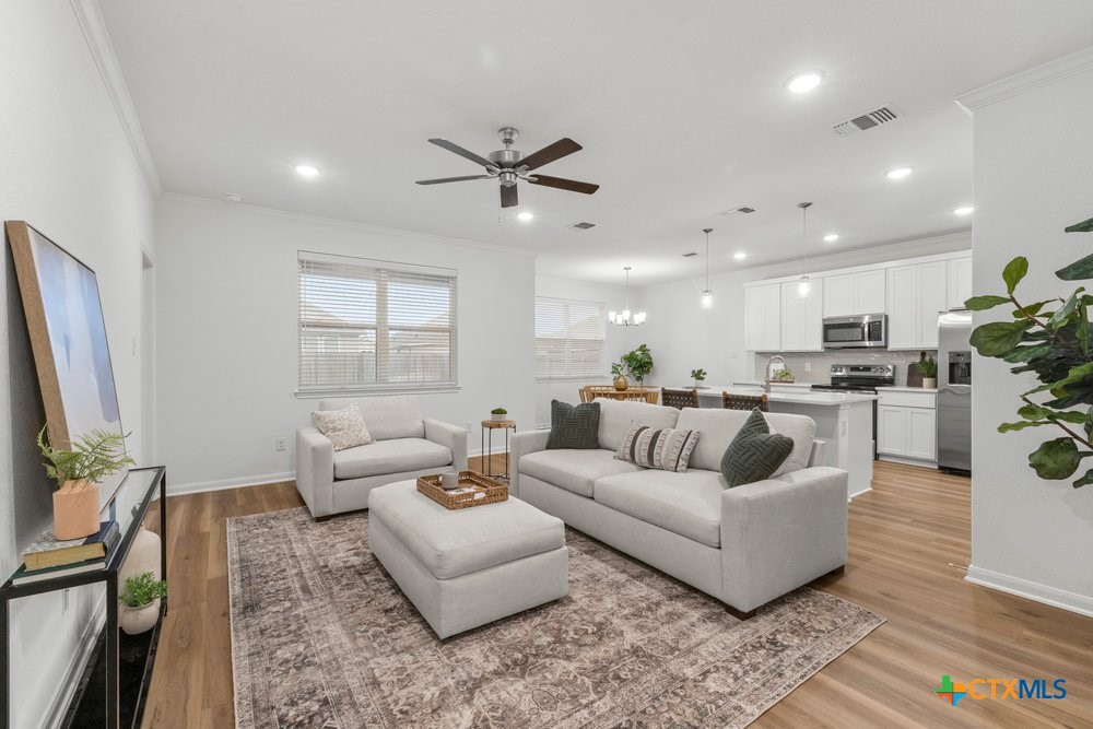 8114 Timber Hollow Lane Temple, TX 76502 - Photo 9 of 34 a living room with furniture white walls and a flat screen tv