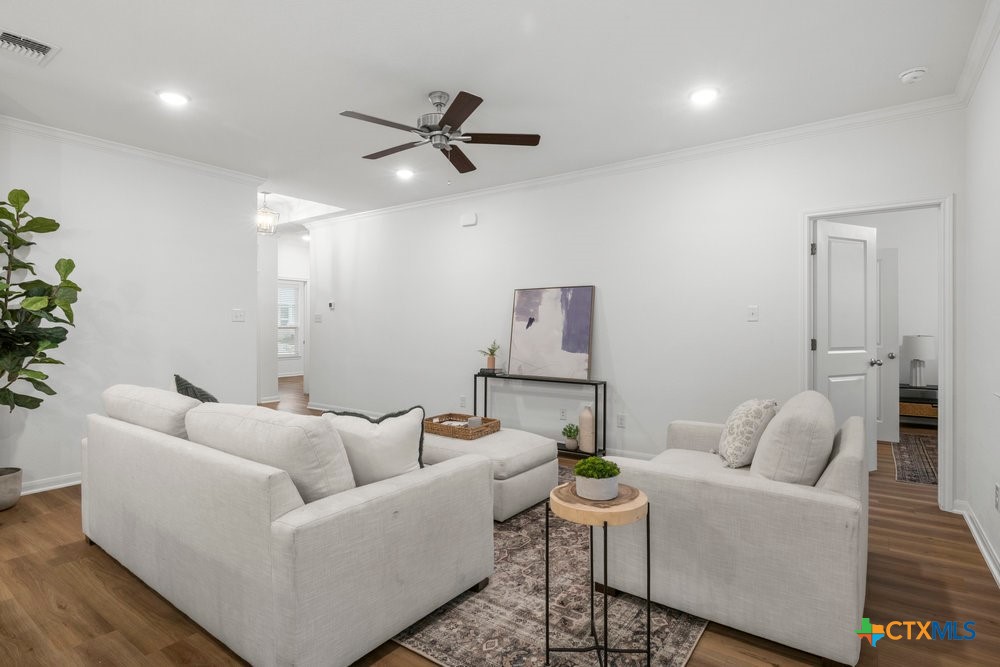 8114 Timber Hollow Lane Temple, TX 76502 - Photo 10 of 34 a living room with furniture and a large wooden floor