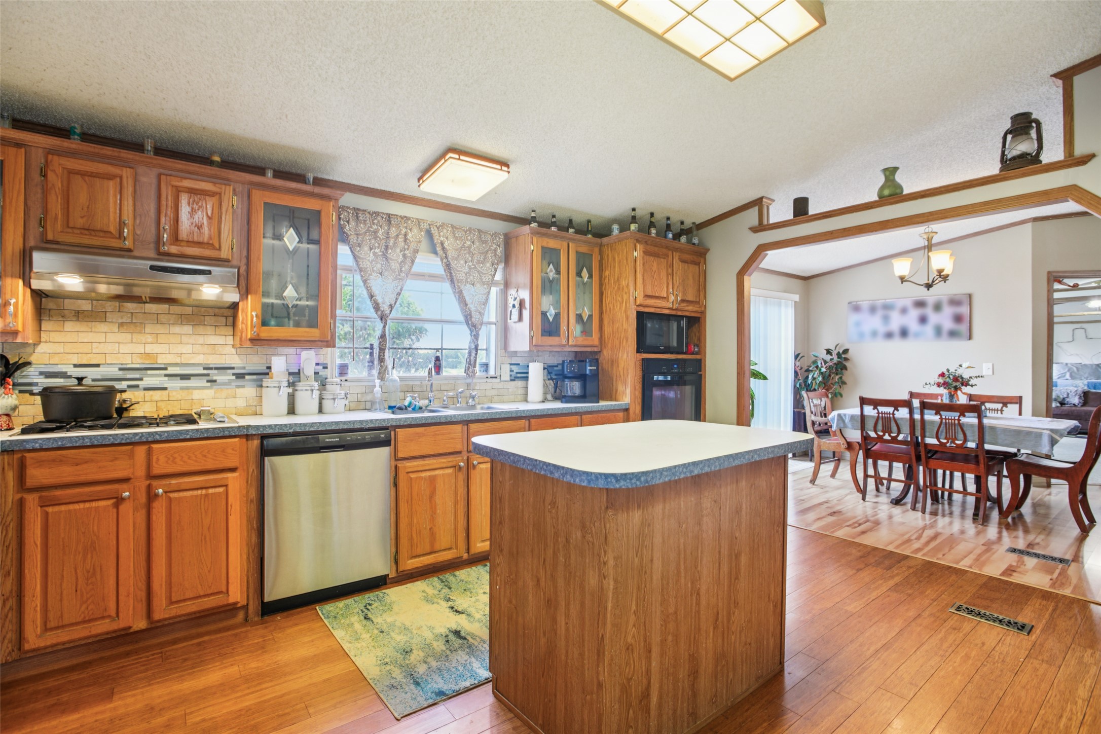 372 Hofferek Road Rosanky, TX 78953 - Photo 11 of 40 a kitchen with stainless steel appliances granite countertop sink stove top oven and cabinets