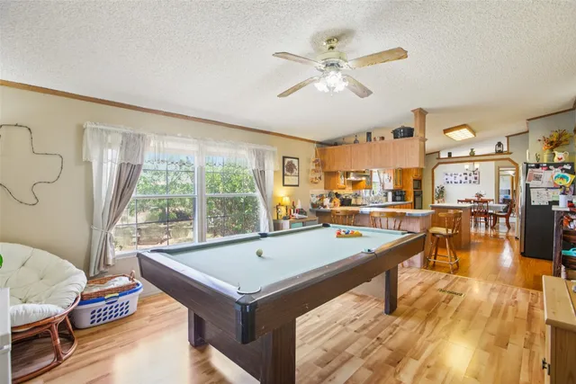 a room with pool table and windows