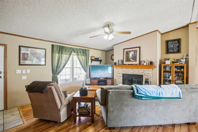 a living room with furniture a flat screen tv and a fireplace