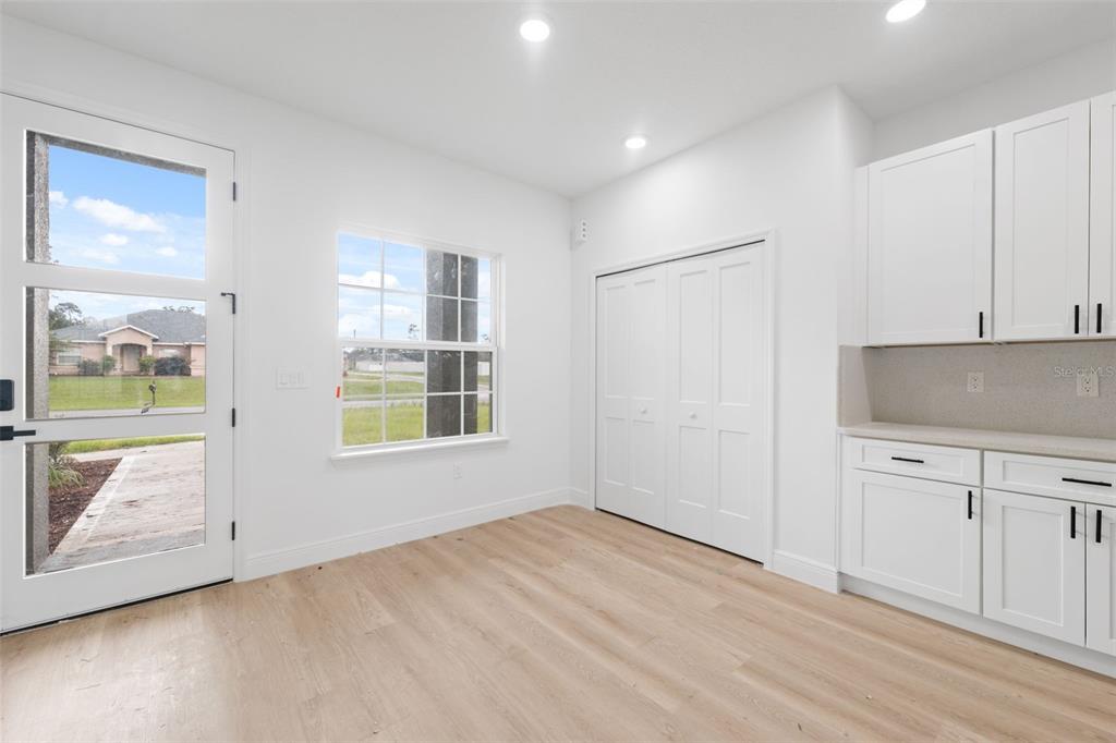 3261 Southwest 129th Loop Ocala, FL 34473 - Photo 16 of 32 a view of an empty room with a window and wooden floor