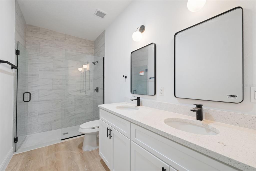 3261 Southwest 129th Loop Ocala, FL 34473 - Photo 20 of 32 a bathroom with a sink a toilet and shower