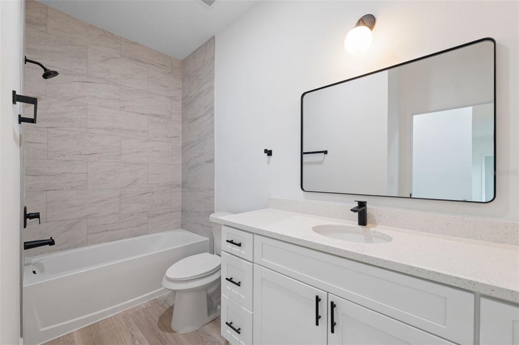 3261 Southwest 129th Loop Ocala, FL 34473 - Photo 24 of 32 a bathroom with a sink toilet and shower