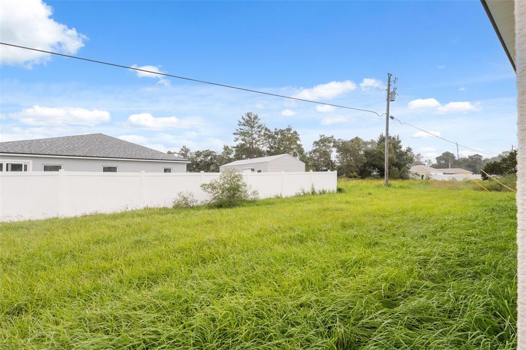 3261 Southwest 129th Loop Ocala, FL 34473 - Photo 32 of 32 a view of a big yard with potted plants