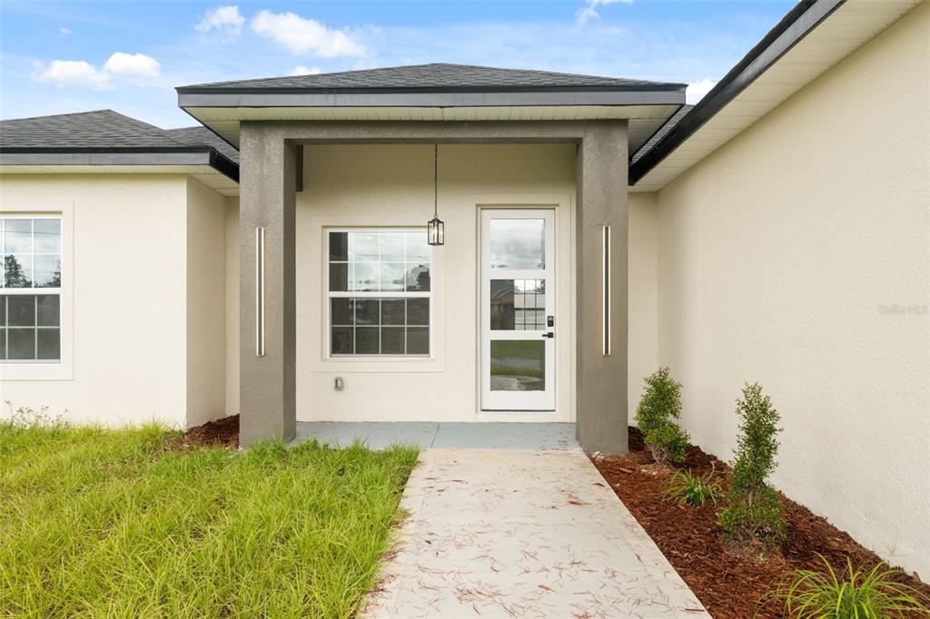 3261 Southwest 129th Loop Ocala, FL 34473 - Photo 5 of 32 a front view of a house with a yard