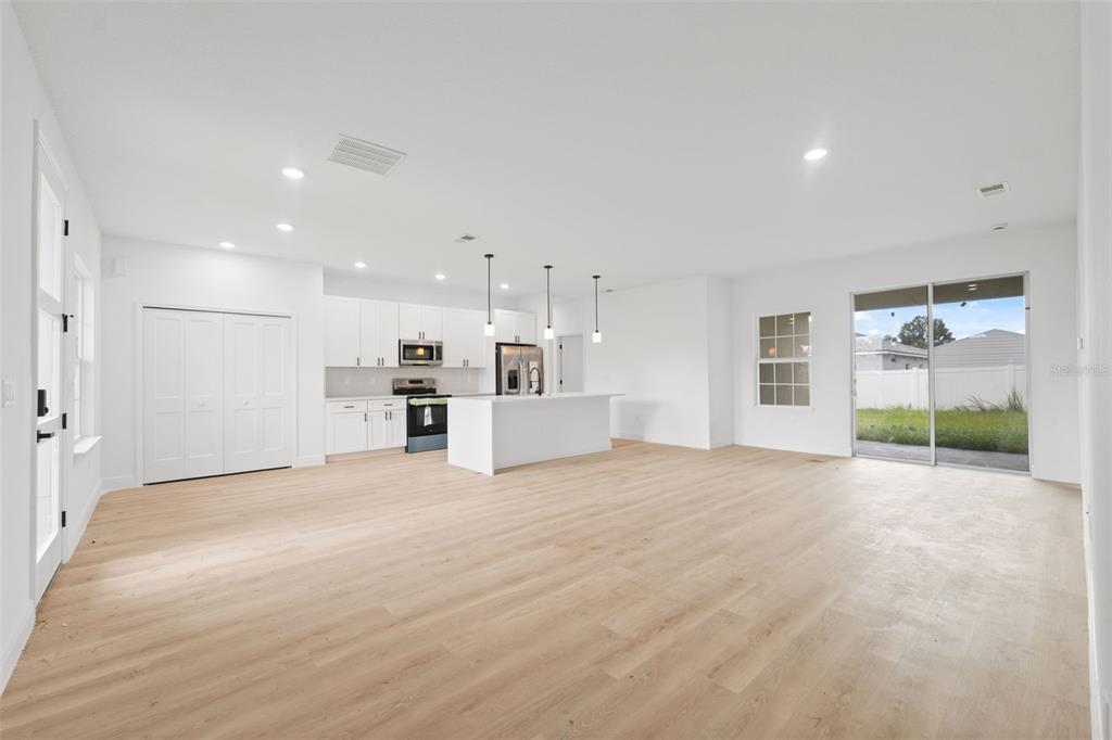 3261 Southwest 129th Loop Ocala, FL 34473 - Photo 8 of 32 a view of an empty room with kitchen and window