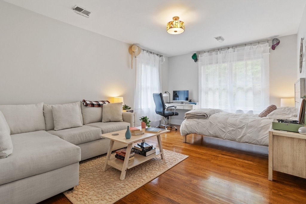 5 Walnut Street Lexington, MA 02421 - Photo 11 of 34 a living room with furniture and a wooden floor