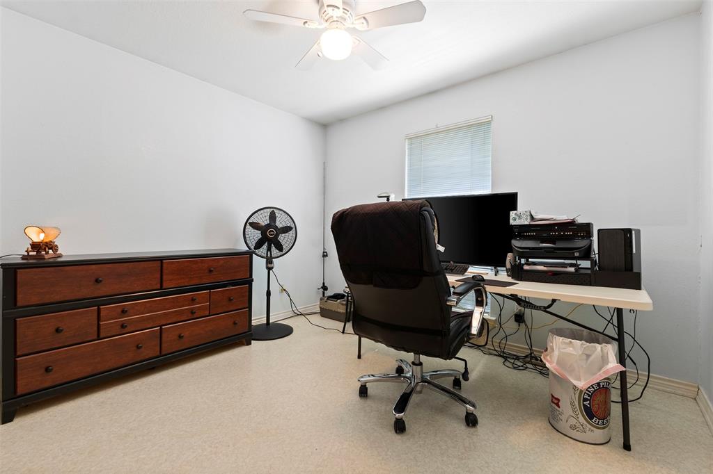 401 Rugged Drive Red Oak, TX 75154 - Photo 25 of 40 Light-colored walls defining a room with light-colored flooring, featuring a ceiling fan with integrated lighting