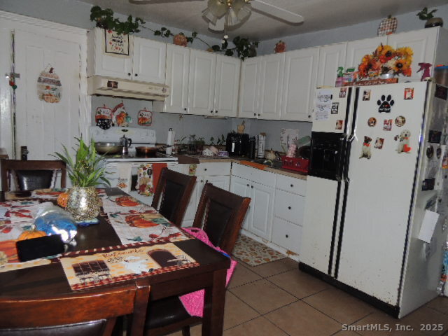 201 Colony Street Meriden, CT 06451 - Photo 11 of 16 a kitchen with stainless steel appliances a stove a refrigerator a sink a dining table and chairs