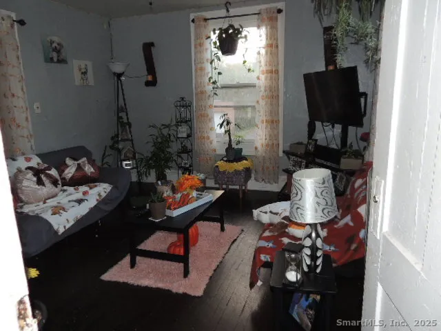 a living room with furniture and wooden floor