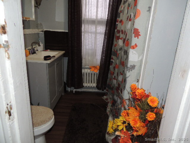 201 Colony Street Meriden, CT 06451 - Photo 15 of 16 a bathroom with a sink toilet and shower curtain