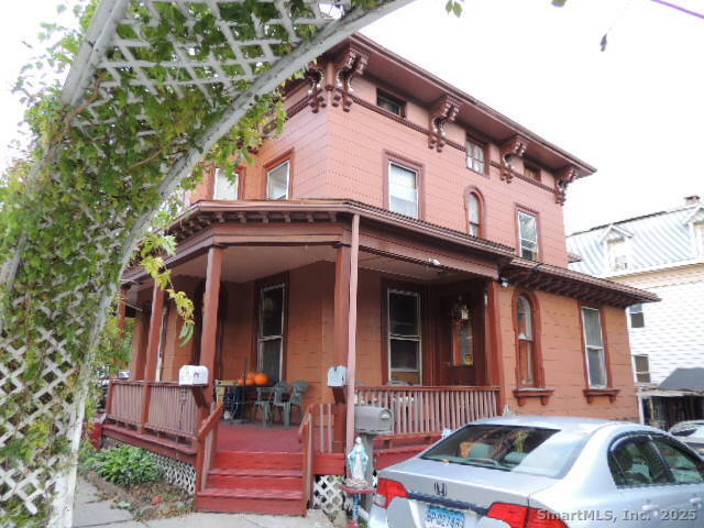 201 Colony Street Meriden, CT 06451 - Photo 2 of 16 a view of a building with large windows and a table and chairs