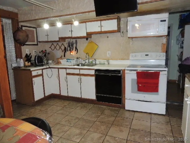 a kitchen with stainless steel appliances granite countertop a sink and cabinets