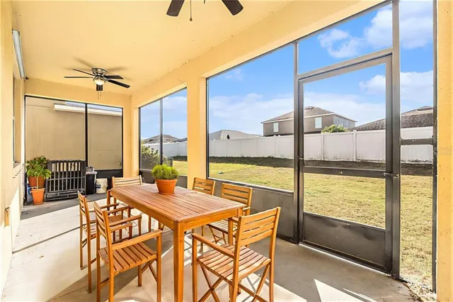 a view of a dining room with furniture and a floor to ceiling window