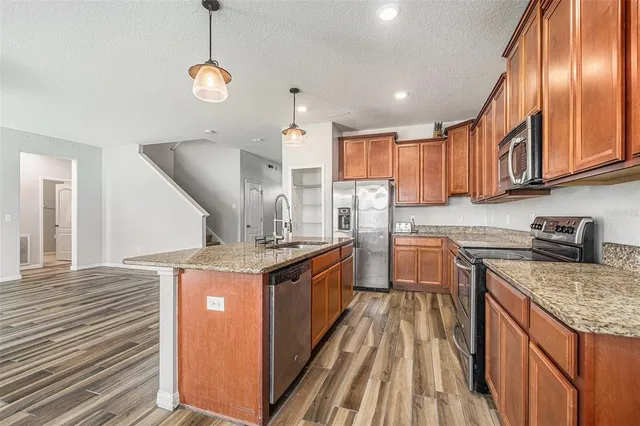 a kitchen with stainless steel appliances granite countertop a stove and a sink