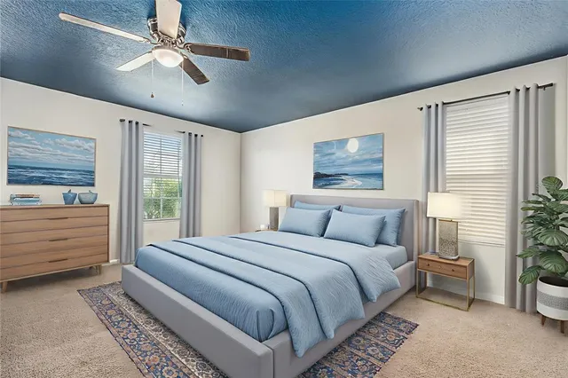 a bed room with a bed and a ceiling fan