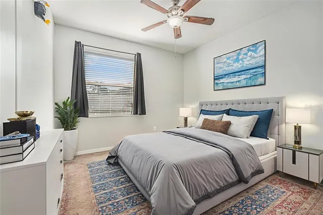 a bedroom with a large bed and a window