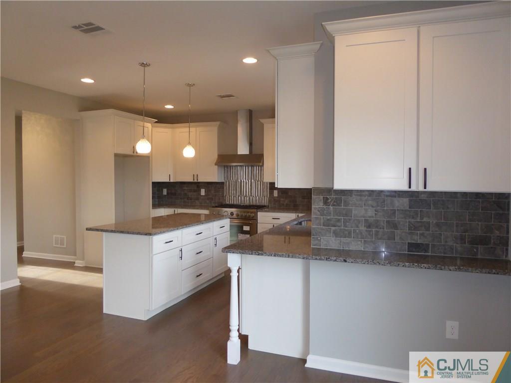 128 Normandy Road Colonia, NJ 07067 - Photo 14 of 41 a large white kitchen with a white countertops and cabinets