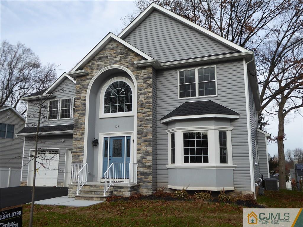 128 Normandy Road Colonia, NJ 07067 - Photo 3 of 41 a front view of a house with a yard