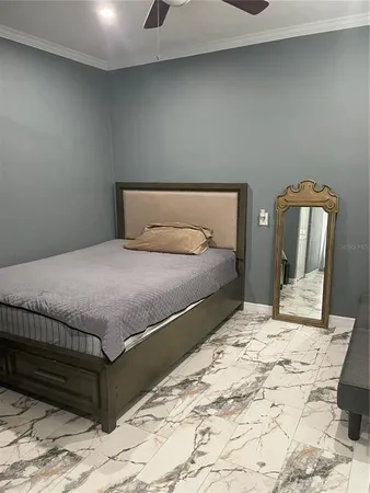 a bedroom with a bed and mirror