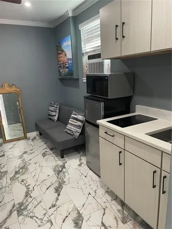 a living room with a bed and cabinets