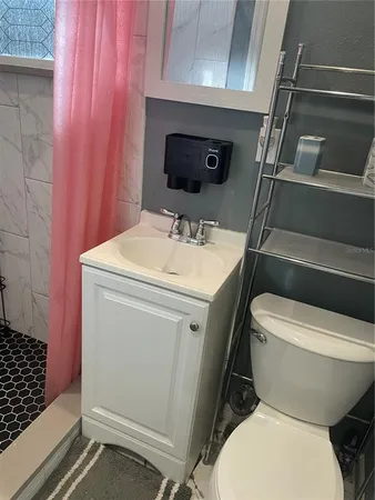 a white toilet sitting next to a bathroom sink