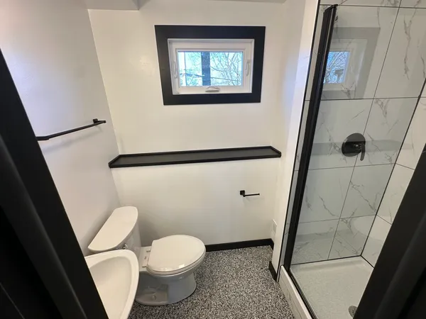 a white toilet sitting next to a sink