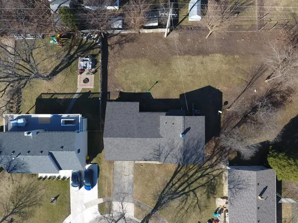 an aerial view of a house with a yard
