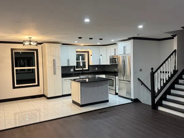 a kitchen with stainless steel appliances a refrigerator and a stove top oven