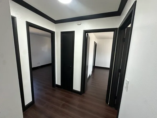 a view of a hallway with wooden floor