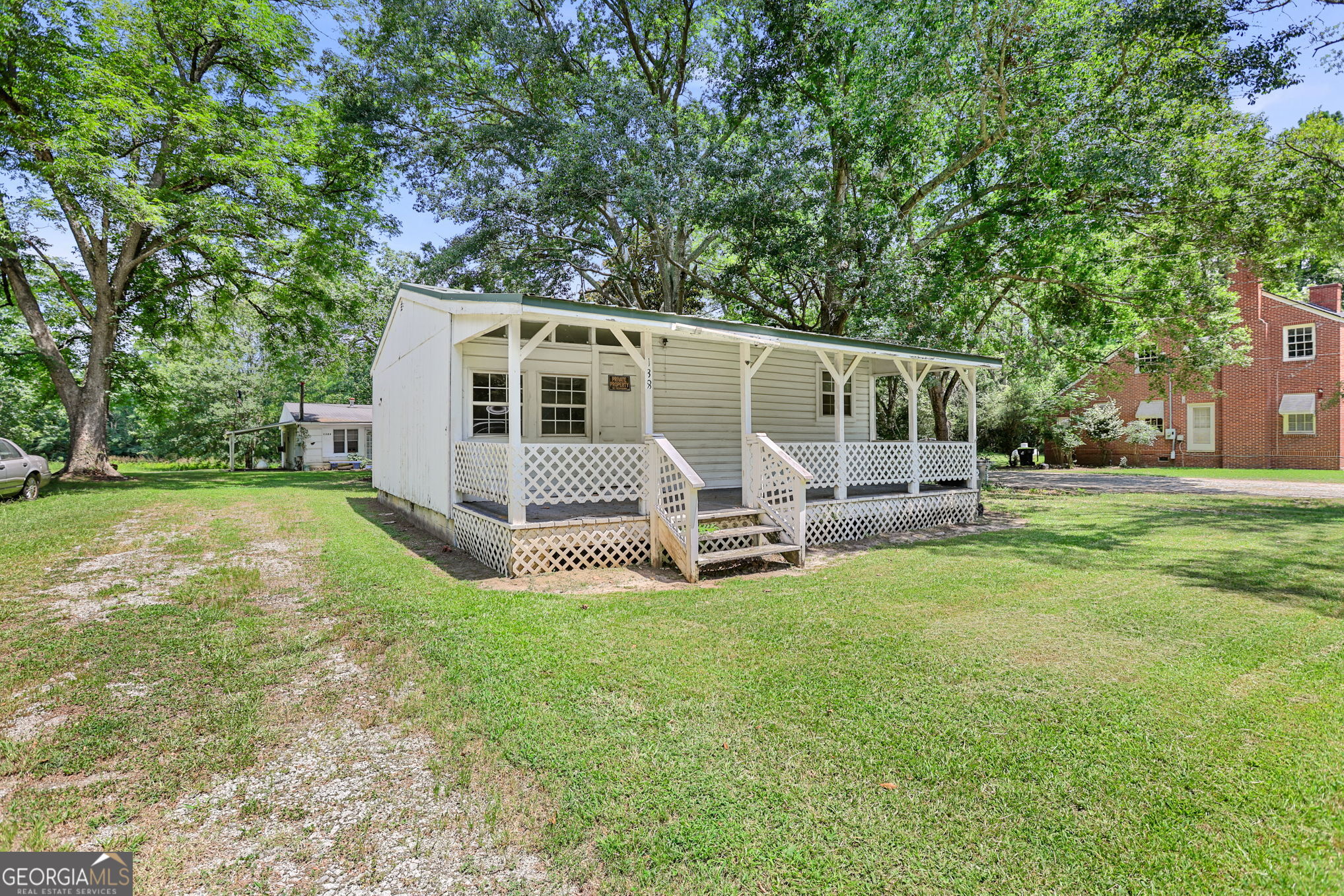 a view of a house with backyard and a tree