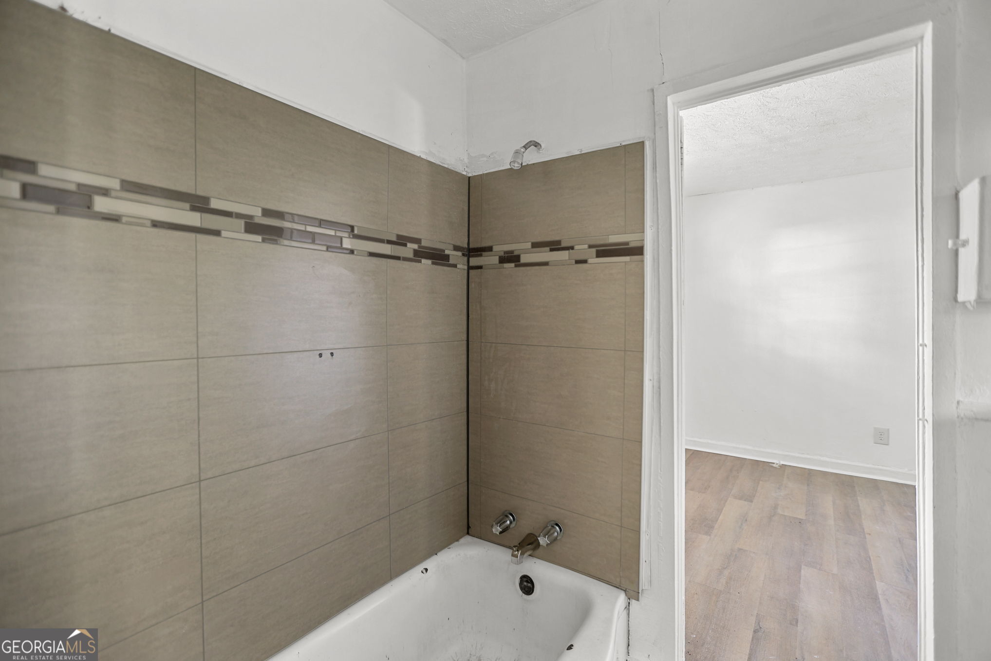 138 Main Street Sharpsburg, GA 30277 - Photo 13 of 34 a bathroom with a bathtub and a shower