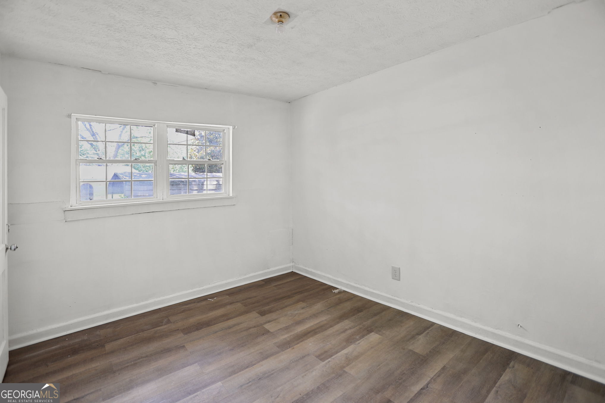 138 Main Street Sharpsburg, GA 30277 - Photo 14 of 34 wooden floor in an empty room with a window