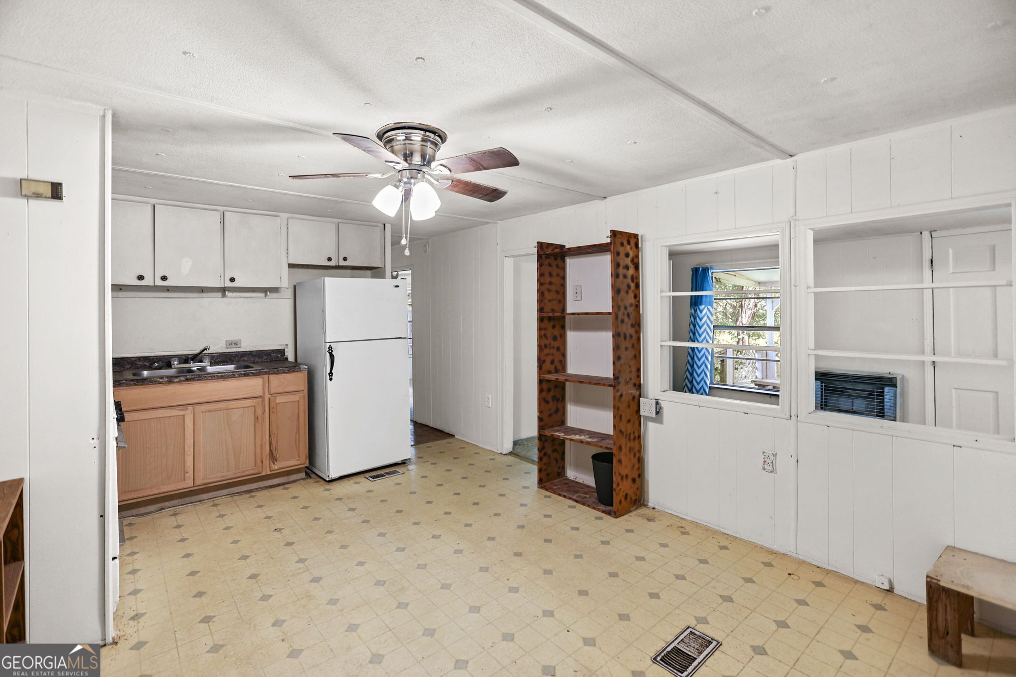 138 Main Street Sharpsburg, GA 30277 - Photo 19 of 34 a kitchen with stainless steel appliances kitchen island granite countertop a refrigerator and a stove top oven
