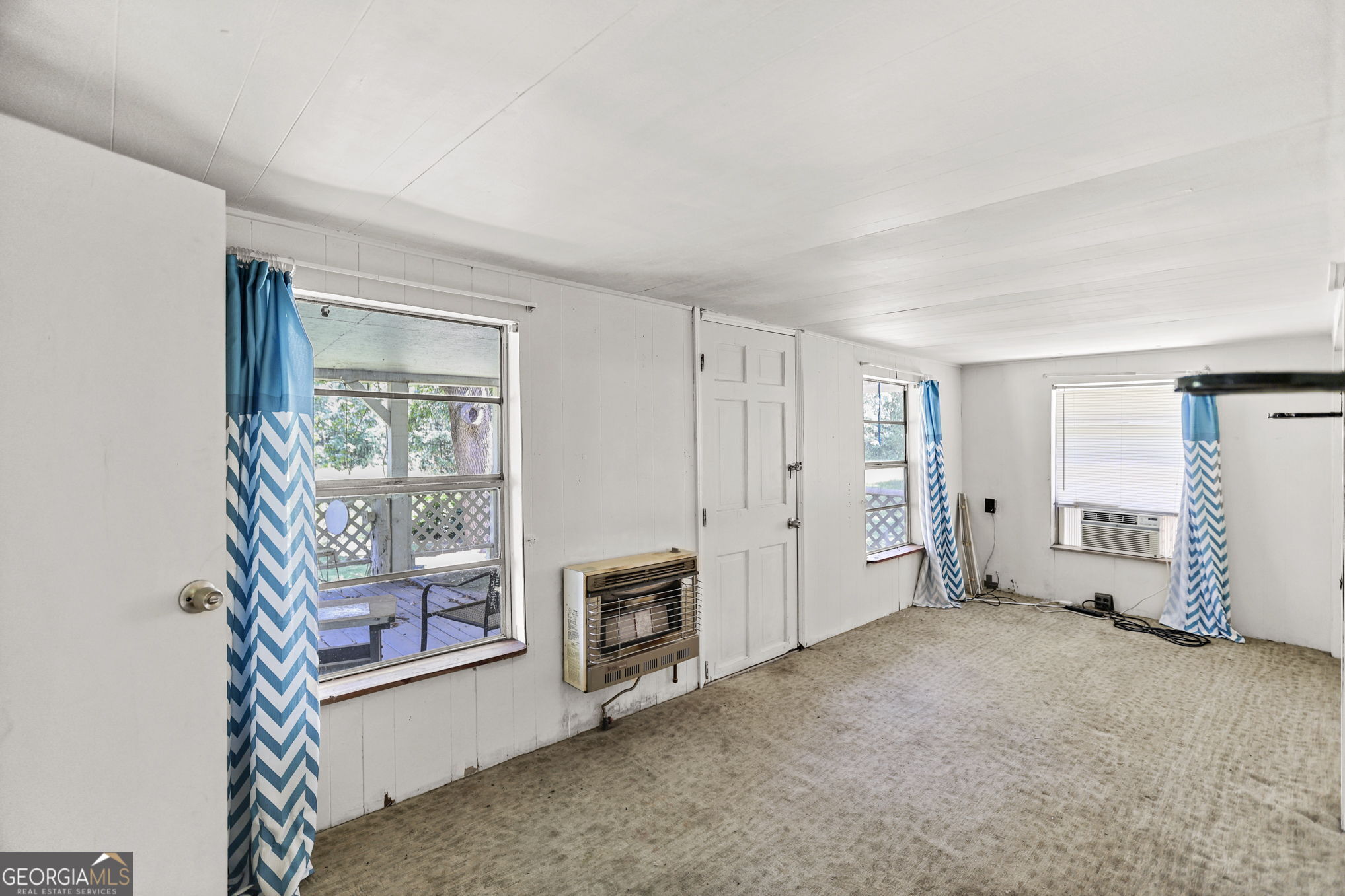 138 Main Street Sharpsburg, GA 30277 - Photo 22 of 34 an empty room with a fireplace and windows