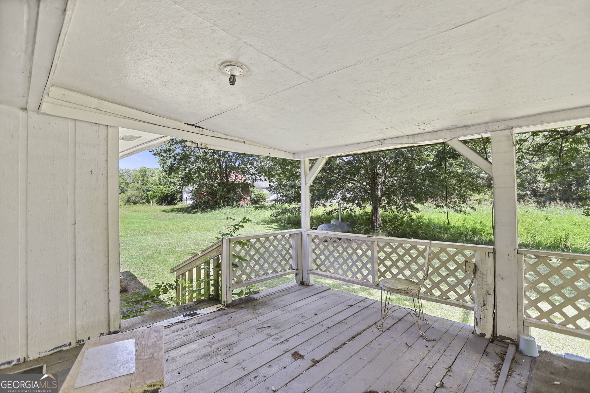 138 Main Street Sharpsburg, GA 30277 - Photo 28 of 34 a view of a deck with wooden floor and floor to ceiling window