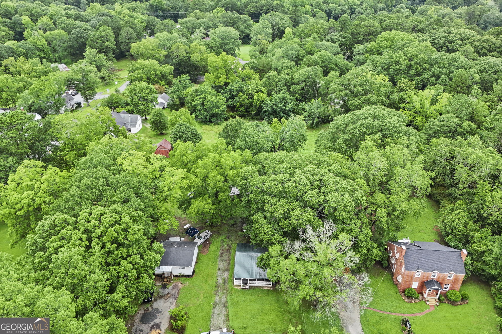 138 Main Street Sharpsburg, GA 30277 - Photo 30 of 34 an aerial view of residential house with outdoor space and trees all around