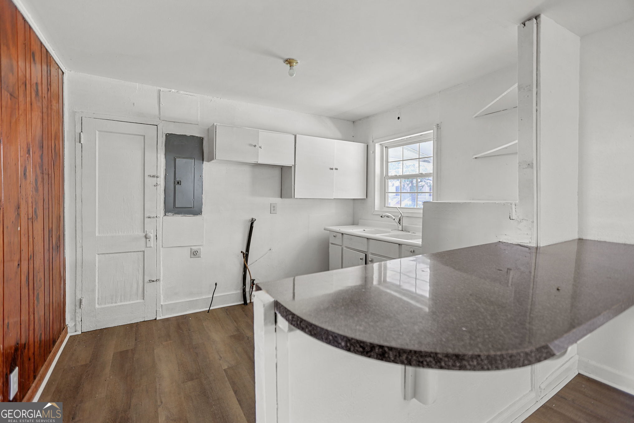 138 Main Street Sharpsburg, GA 30277 - Photo 8 of 34 a kitchen with kitchen island a sink a stove and a refrigerator
