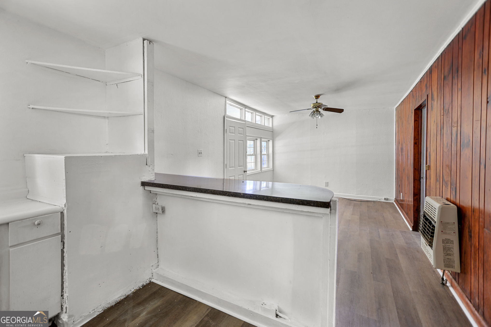 138 Main Street Sharpsburg, GA 30277 - Photo 9 of 34 a kitchen with cabinets and wooden floor