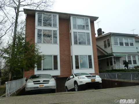 157-02 Station Road, Unit C Queens, NY 11355 - Photo 1 of 1 a car parked in front of a house