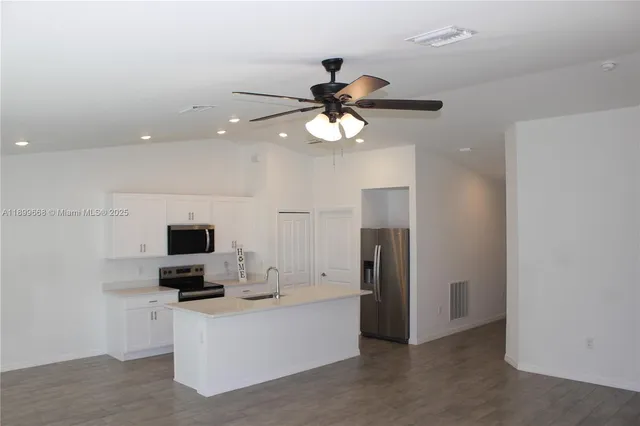 a kitchen with a sink a stove and refrigerator