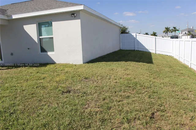 a view of a house with a yard and a garage