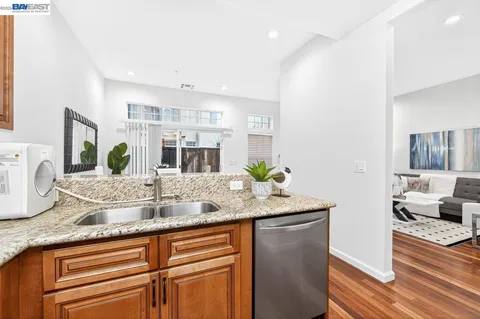 a bathroom with double vanity and a mirror