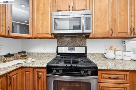 a stove top oven sitting inside of a kitchen