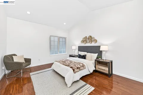 a bedroom with a bed and a chair