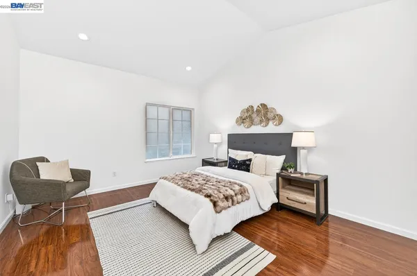 a bedroom with a bed and a chair